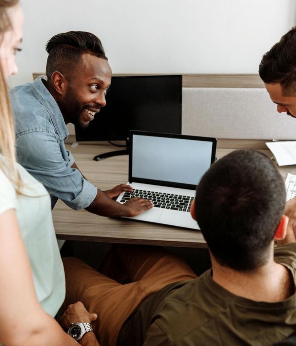 Team of tech enthusiasts collaborating in modern office environment